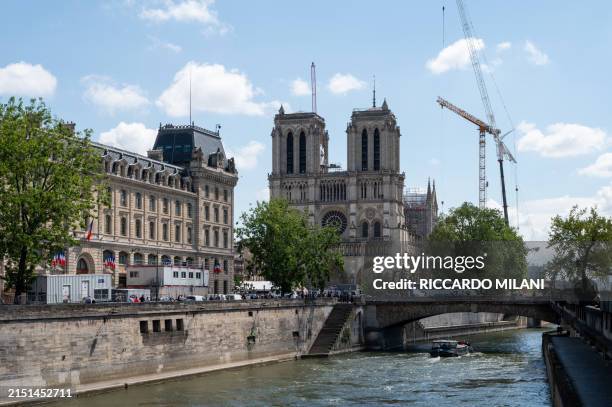 The Cathedral of Notre-Dame de Paris and the Seine River seen from the Pont Saint-Michel in Paris, France, on May 7, 2024. Reconstruction of the roof...