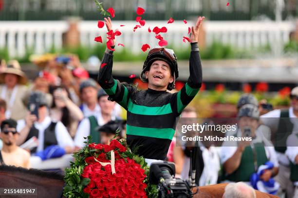 Jockey Brian J. Hernandez Jr., on top of Mystik Dan, celebrates in the winner circle after winning the 150th running of the Kentucky Derby at...