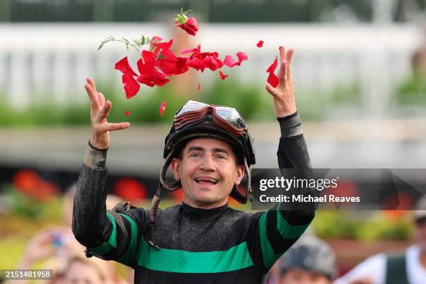 Jockey Brian J. Hernandez Jr., on top of Mystik Dan, celebrates in the winner circle after winning the 150th running of the Kentucky Derby at...