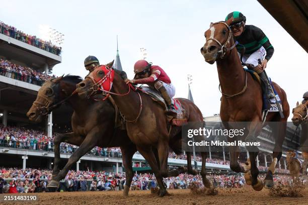 Mystik Dan, ridden by jockey Brian J. Hernandez Jr. , crosses the finish line ahead of Sierra Leone, ridden by jockey Tyler Gaffalione and Forever...