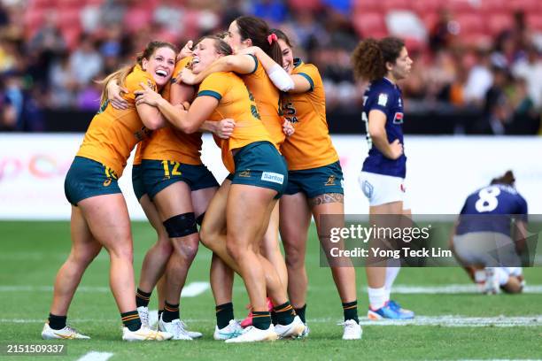 Australia players celebrate after the women's cup semifinal match victory over France during day three of the HSBC SVNS Singapore at the National...