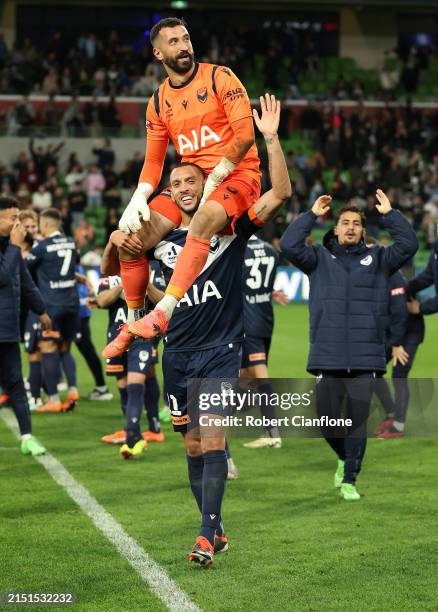 Victory goalkeeper Paul Izzo and Roderick Miranda of the Victory celebrate after the Victory defeated Melbourne City in a penalty shootout during the...