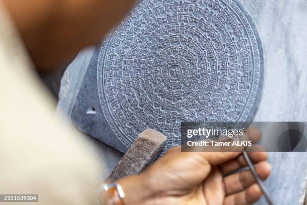 a man's hands carving buddhist designs into stone - kathmandu stock pictures, royalty-free photos & images