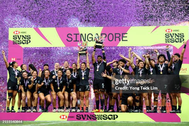 The New Zealand men's and women's teams celebrate with their trophies after winning their respective cup final matches during day three of the HSBC...