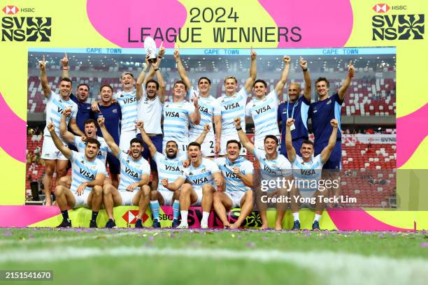Argentina players celebrate with the trophy after winning the SVNS League during day three of the HSBC SVNS Singapore at the National Stadium on May...