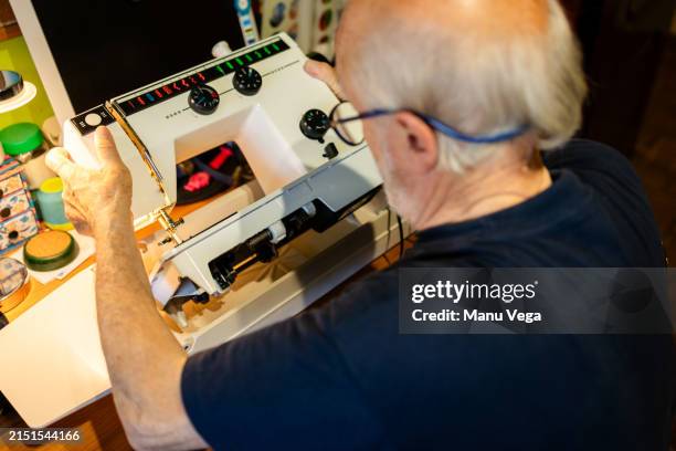 senior man repair with sewing machine in workshop - sewing machine stock pictures, royalty-free photos & images