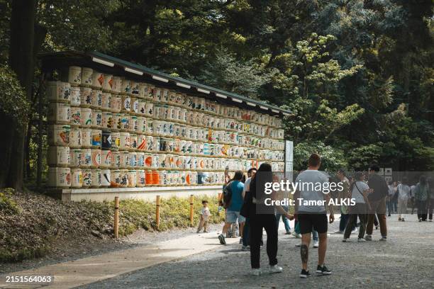 colorful sake barrels at the meiji jingu shrine - meiji jingu shrine stock pictures, royalty-free photos & images