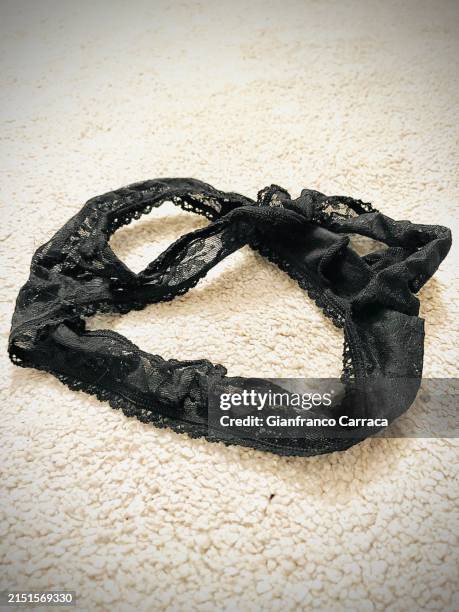used women's underwear on white carpet - désir photos et images de collection