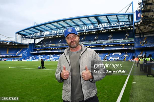 Actor and Film Producer Gerard Butler poses for a photo after the Premier League match between Chelsea FC and West Ham United at Stamford Bridge on...