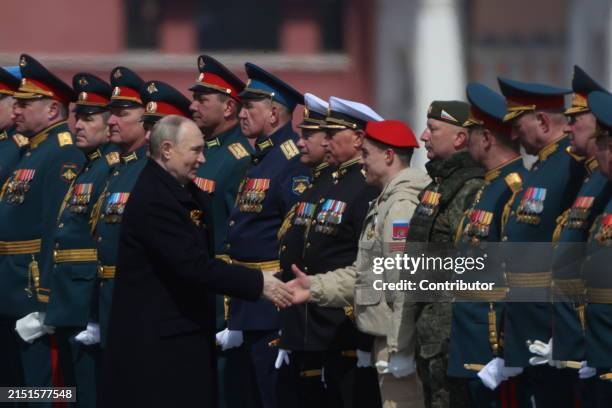 Russian President Vladimir Putin greets highest ranked officers during the Victory Day parade at Red Square on May 9, 2024 in Moscow, Russia. The...