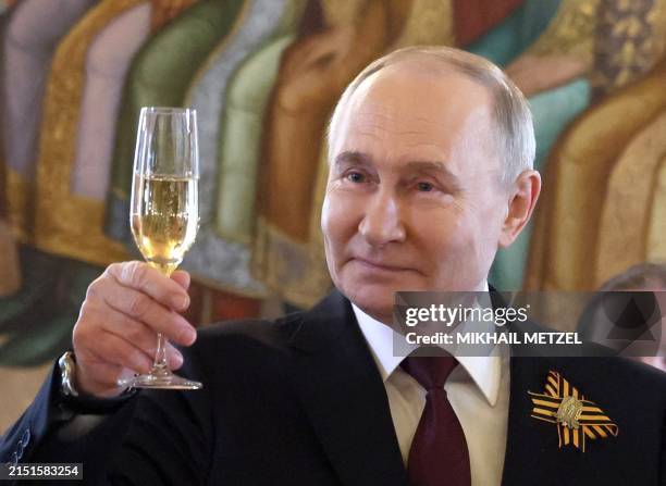 In this pool photograph distributed by the Russian state agency Sputnik, Russia's President Vladimir Putin hosts a reception in honour of foreign...