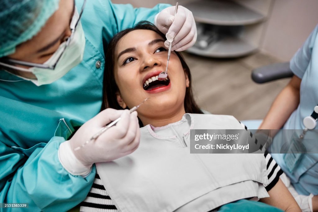 Young woman having her teeth checked by dentistry