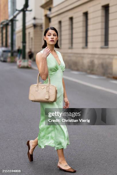 Lea Naumann wears mint green sleeveless dress : ottod'Ame, beige bag Prada, brown silk heels Prada on May 05, 2024 in Berlin, Germany.