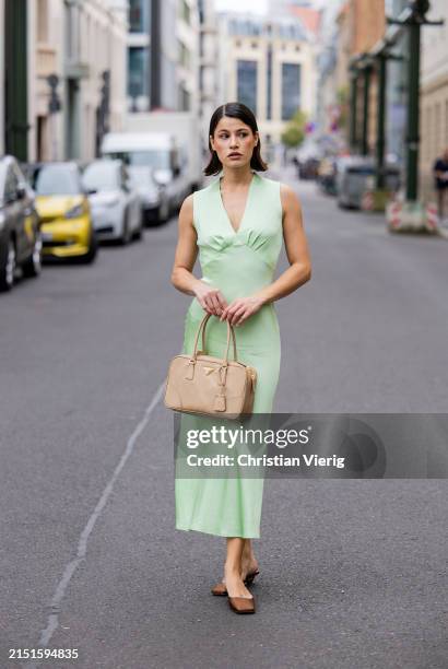 Lea Naumann wears mint green sleeveless dress : ottod'Ame, beige bag Prada, brown silk heels Prada on May 05, 2024 in Berlin, Germany.