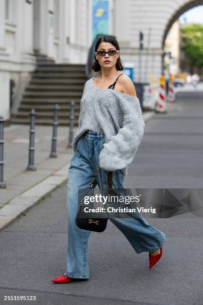 Lea Naumann wears sunglasses Vogue eyewear, bralette / bra / underwear Aubade Paris, grey asymmetric pullover / knit H&M, bag Gucci horsebit 1955,...