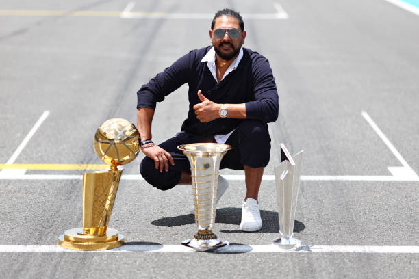 Yuvraj Singh with the Formula One World Championship trophy, Larry O'Brien Championship Trophy and the ICC Men's T20 World Cup trophy on the grid...