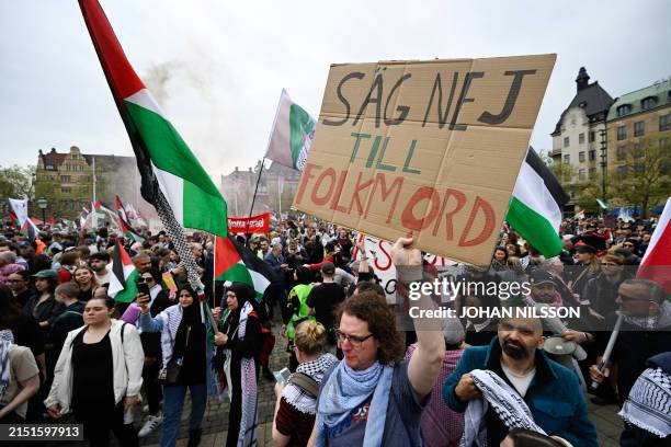 Protester holds up a sign reading "Say no to genocide" during a rally in Malmo, Sweden, in protest against Israel's participation in the 68th edition...