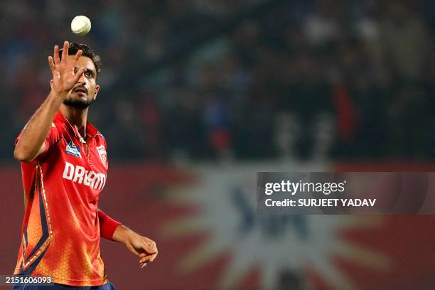 Punjab Kings' Harshal Patel catches the ball during the Indian Premier League Twenty20 cricket match between Punjab Kings and Royal Challengers...