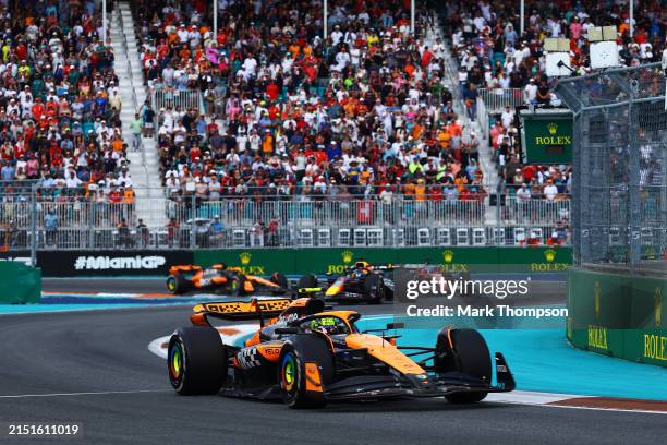 Lando Norris of Great Britain driving the McLaren MCL38 Mercedes leads Max Verstappen of the Netherlands driving the Oracle Red Bull Racing RB20...