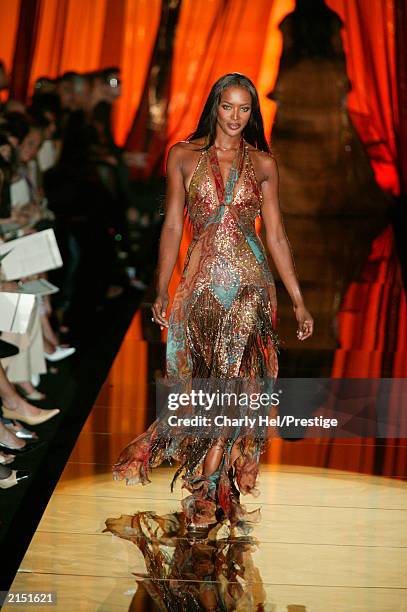 Top model Naomi Campbell wears items by Lebanese fashion designer Elie Saab during his Fall-Winter 2003-2004 Haute Couture fashion collection July...