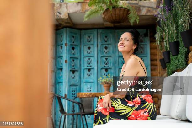 woman is drinking her coffee in her home - latin script stock pictures, royalty-free photos & images