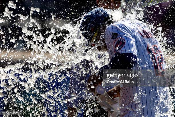 Francisco Lindor of the New York Mets is doused with water after his 11th inning walk off double win the game against the Chicago Cubs 7-6 during...
