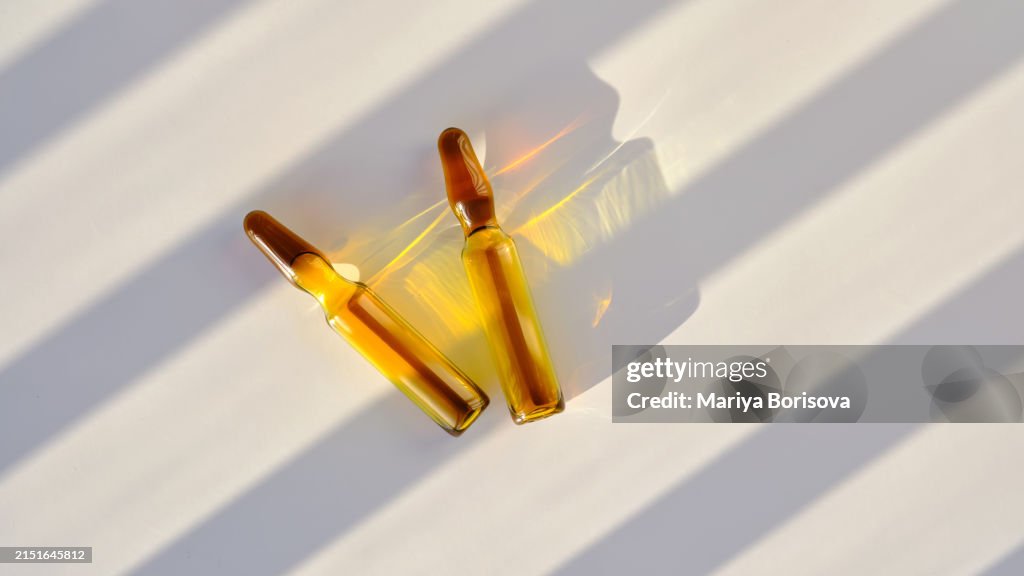 Ampoules against a background of stripes of light.