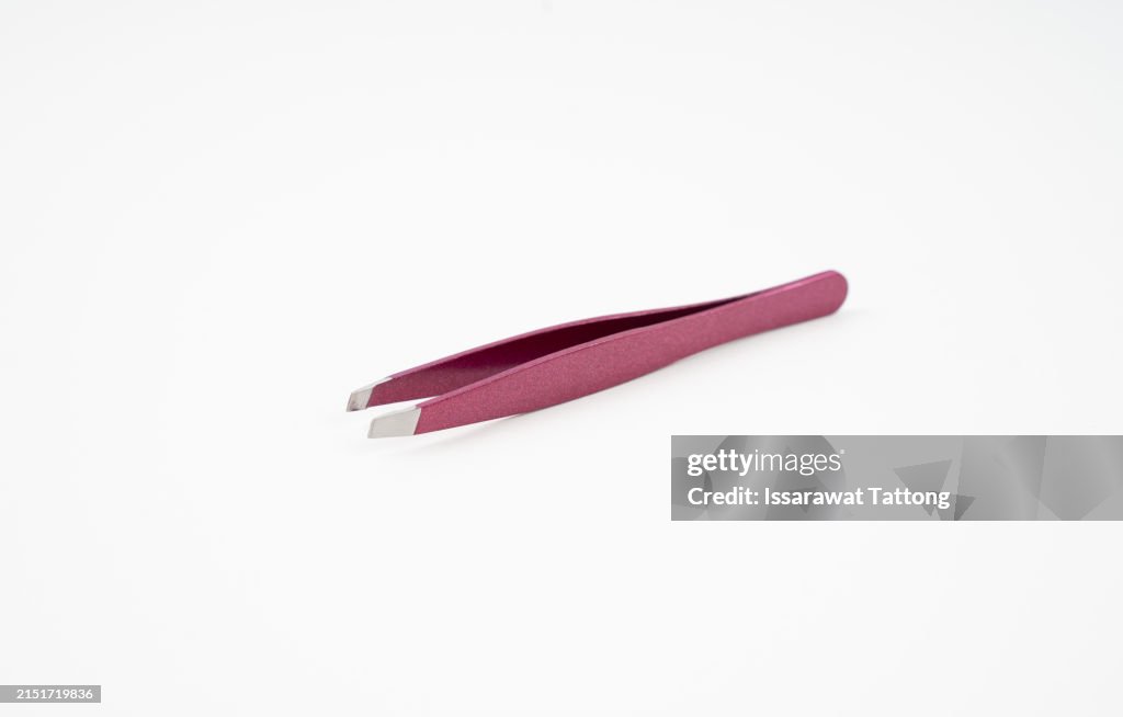 Bright pink cosmetic eyebrow tweezers isolated on white background