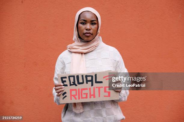 young woman student on strike marching for equal rights - freedom of speech stock pictures, royalty-free photos & images