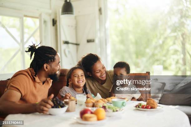 happy black family having breakfast at dining table. - family home stock pictures, royalty-free photos & images
