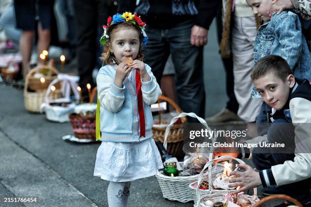 Little girl waits for the Easter baskets’ consecration ceremony on the Easter Eve, the Holy Saturday, at the Kyiv's church on May 4, 2024 in Kyiv,...