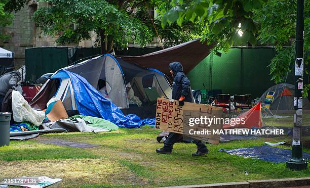 Maintenance staff and waste disposal crews clean up after police cleared a pro-Palestinian protest encampment on the campus of the University of...