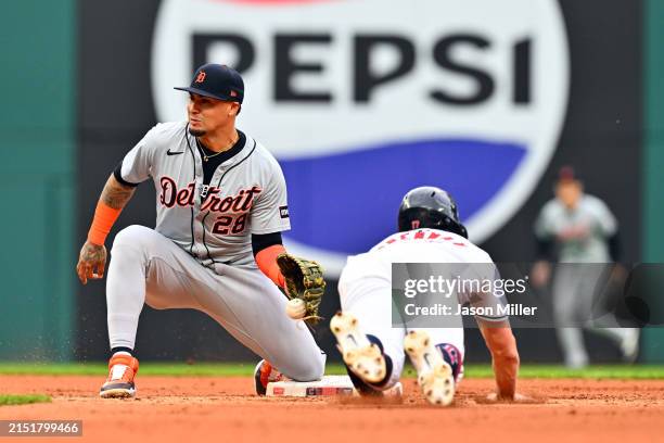 Shortstop Javier Báez of the Detroit Tigers catches Will Brennan of the Cleveland Guardians stealing second during the fourth inning at Progressive...