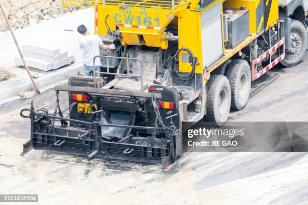 workers laying pavement - paving contractor stock pictures, royalty-free photos & images