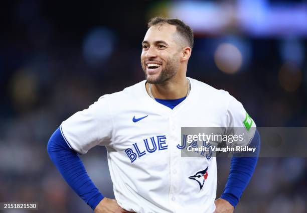 George Springer of the Toronto Blue Jays jokes with players in the Kansas City Royals dugout during a game at Rogers Centre on May 01, 2024 in...
