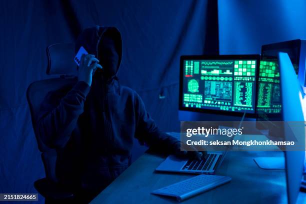 computer hacker using phone. - credit card theft stock pictures, royalty-free photos & images