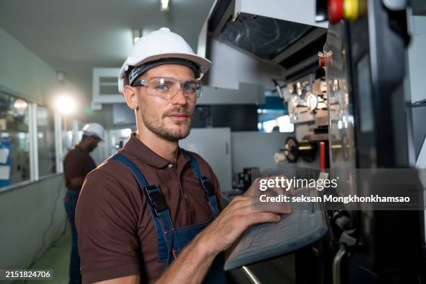 factory worker programming a cnc machine - finger goggles stock pictures, royalty-free photos & images