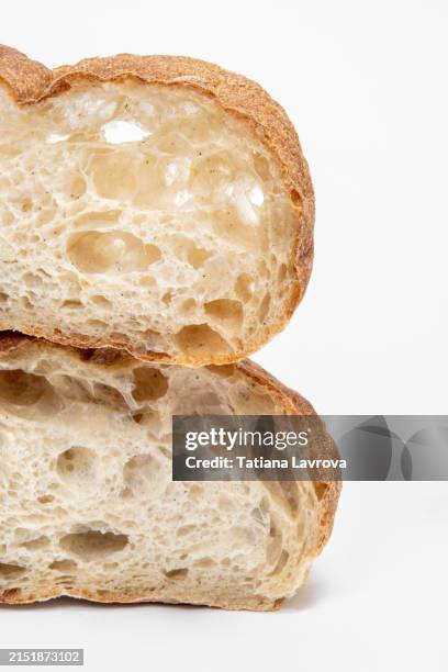 close up view of a freshly baked artisan bread loaf sliced in half and cropped by frame. commercial photography for bakery design projects - brötchen freisteller stock-fotos und bilder