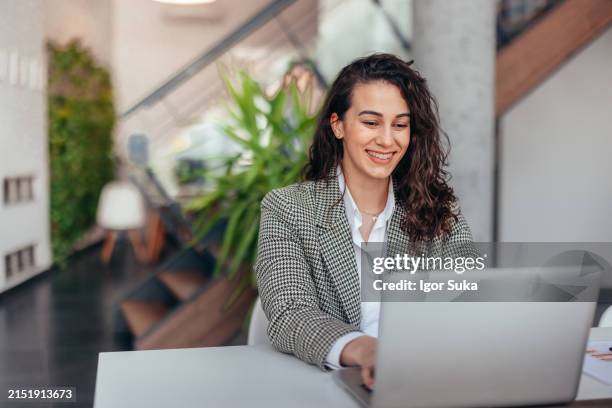 successful businesswoman using laptop, working in office. business technology corporate concept - office wellbeing stock pictures, royalty-free photos & images