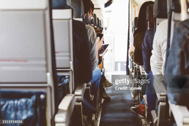 rear view of commercial airliner cabin - commercial jet stock pictures, royalty-free photos & images