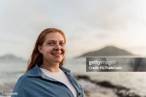 portrait of a mid adult woman on the beach - characters stock pictures, royalty-free photos & images