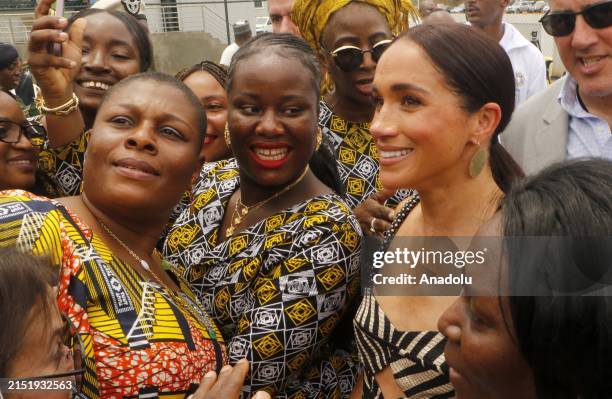 Britain's Prince Harry , Duke of Sussex, and Britain's Meghan , Duchess of Sussex, attend an exhibition sitting volleyball match at Nigeria...