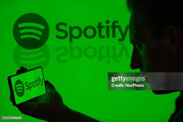 The Spotify logo is being displayed on a smartphone with Spotify visible in the background in this photo illustration in Brussels, Belgium, on May...