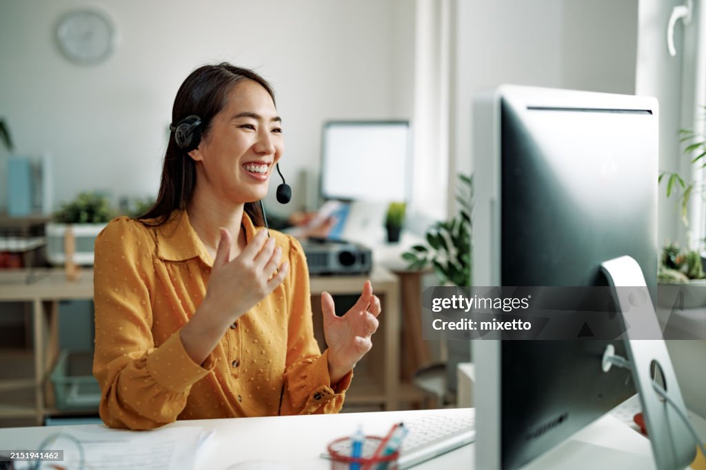 Well dressed businesswoman working as call center customer representative at the office