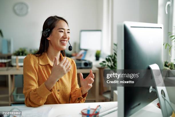well dressed businesswoman working as call center customer representative at the office - callcenter bildbanksfoton och bilder