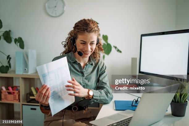 smiling woman talking with customer online, showing document - teacher zoom stock pictures, royalty-free photos & images