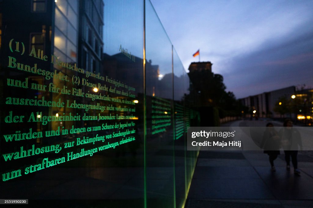 German Basic Rights People walk past text of Germany's Basic Law, the Grundgesetz, etched ...
