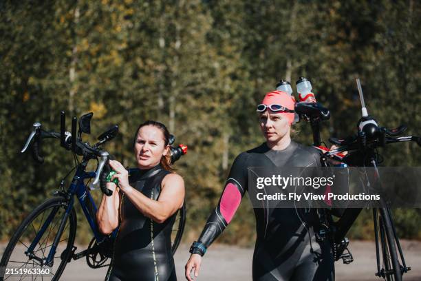 female triathletes training together - triathlon stock pictures, royalty-free photos & images