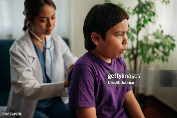 female doctor examining boy - respiratory infection stock pictures, royalty-free photos & images