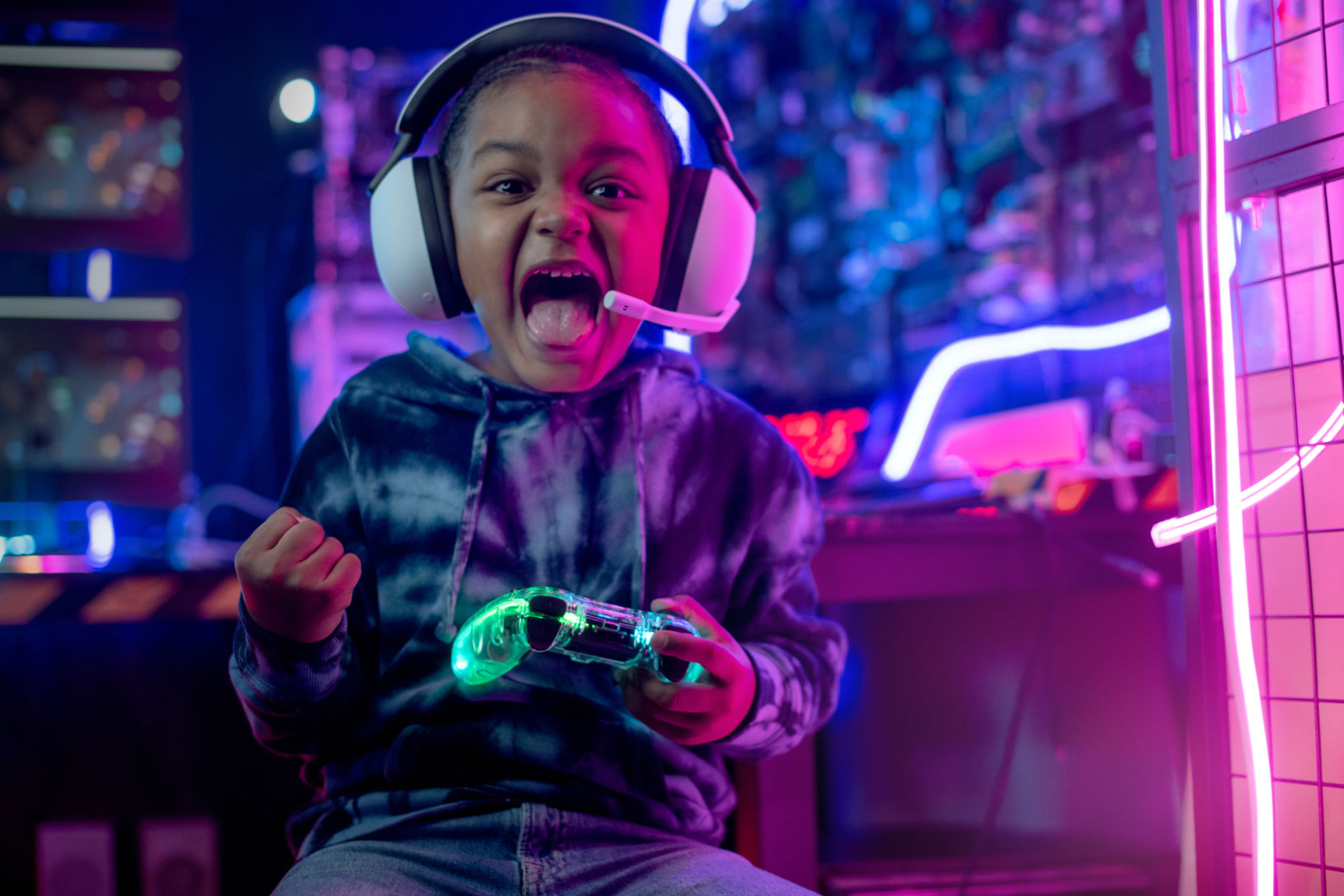 African child boy wear headphone excited playing video game African child boy wear headphone excited playing video game